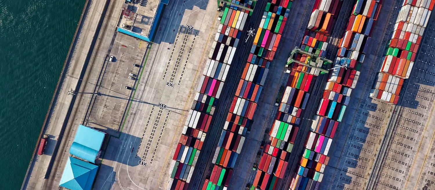 Aerial view of a container terminal with stacked shipping containers