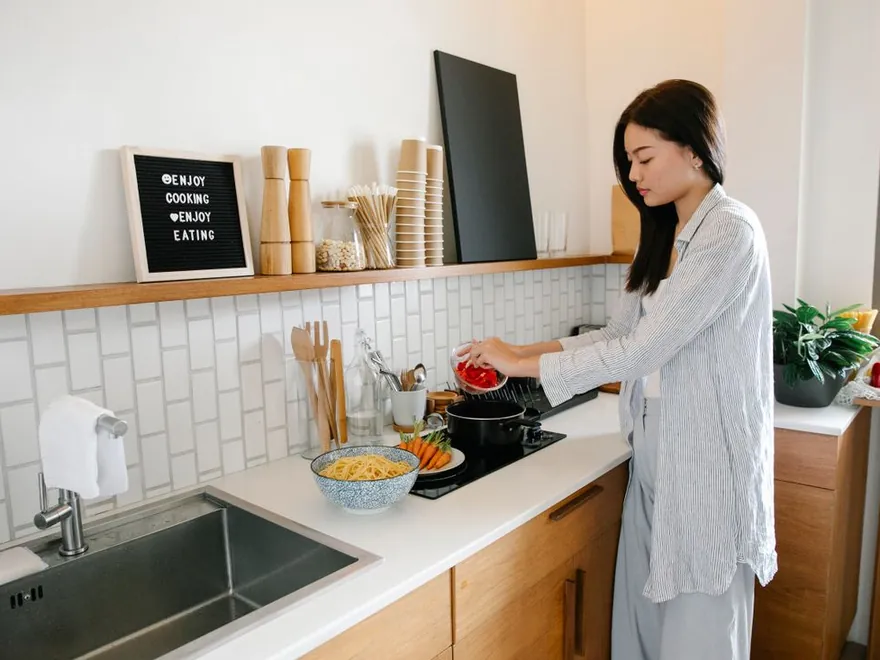 Cooking with pots and utensils in a kitchen